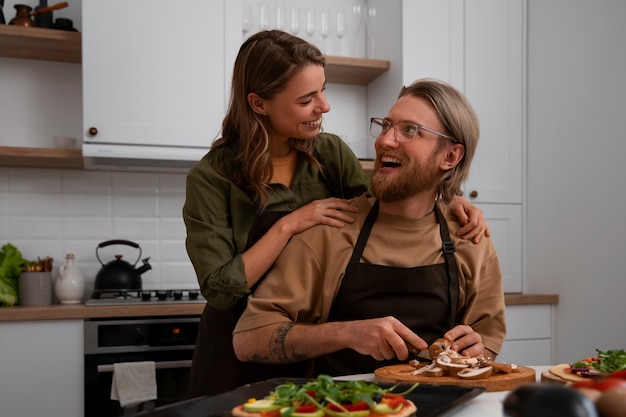 Medium shot couple cooking together