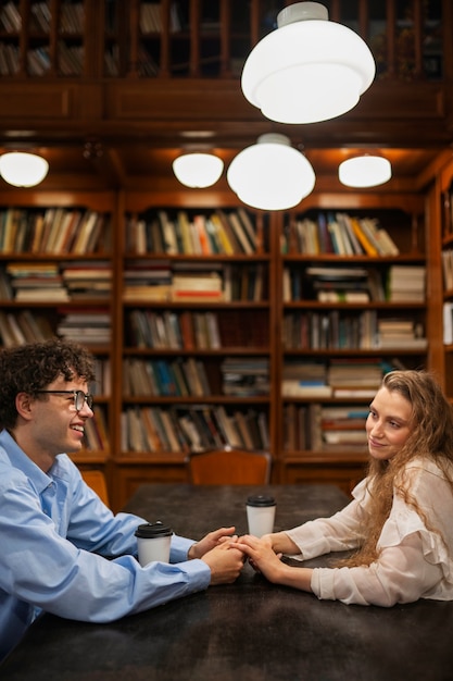 Free Photo medium shot couple having a bookstore date