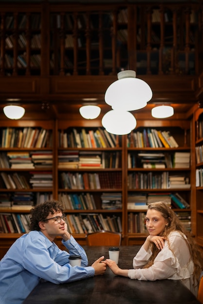 Free photo medium shot couple having a bookstore date