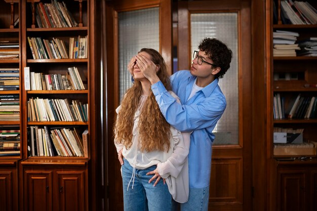 Medium shot couple having a bookstore date