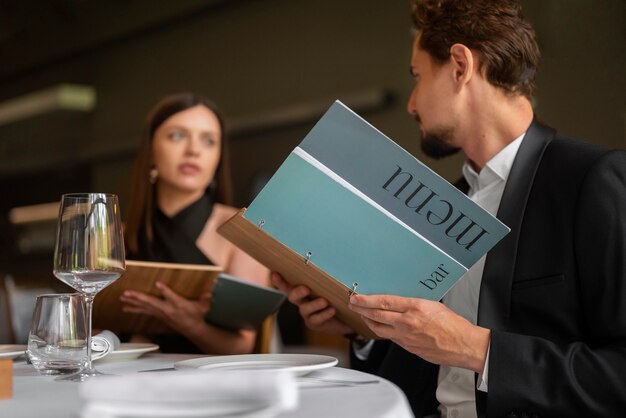 Medium shot couple having  lunch in luxury restaurant