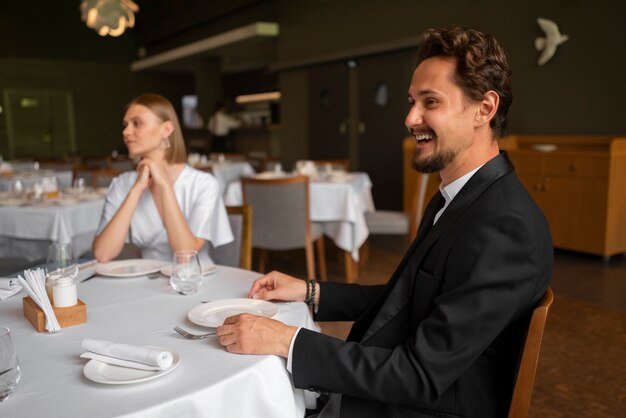 Medium shot couple having  lunch in luxury restaurant