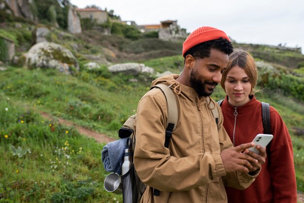 Medium shot couple hiking together