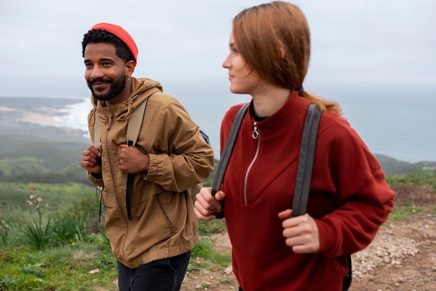 Medium shot couple hiking together