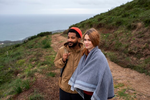 Free photo medium shot couple hiking together