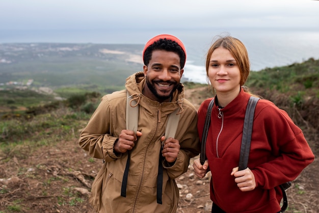 Medium shot couple hiking together