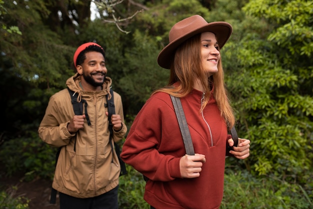 Medium shot couple hiking together