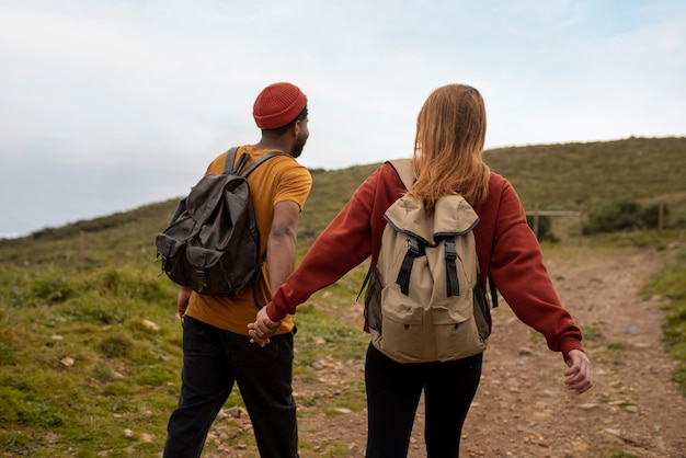 Medium shot couple hiking together