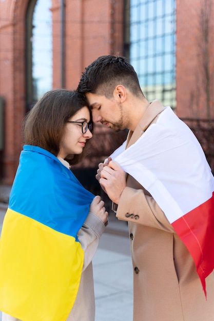 Free Photo medium shot couple holding flags