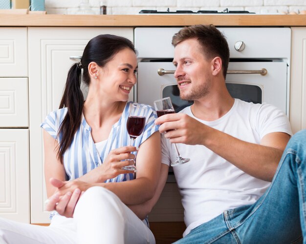 Medium shot couple holding glasses