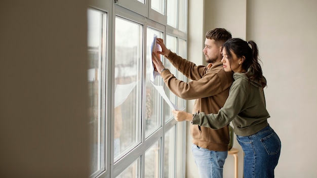 Free photo medium shot couple holding plan