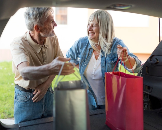 Medium shot couple holding shopping bags