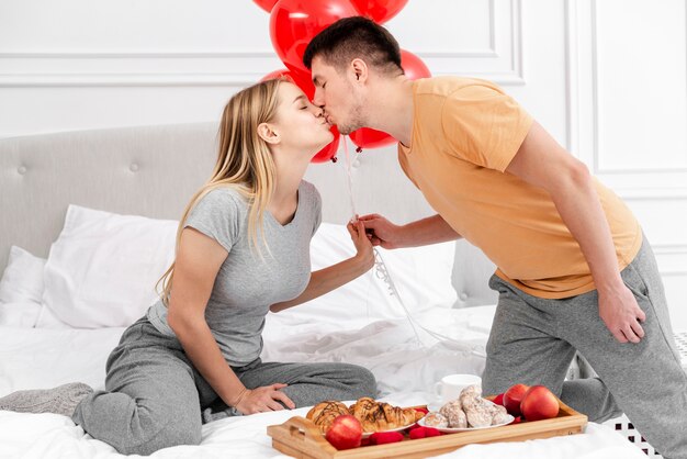 Medium shot couple kissing on valentine's day