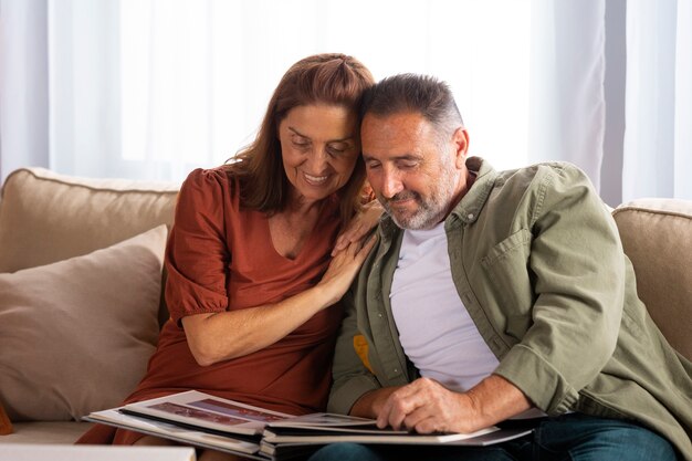 Medium shot couple looking at picture album