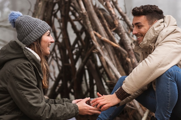 Free Photo medium shot couple near branch shelter