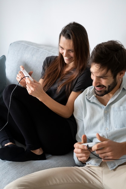 Medium shot couple playing video games