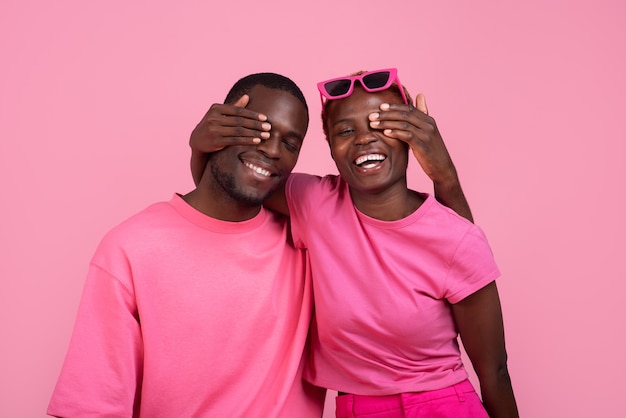 Free photo medium shot couple posing with pink outfit