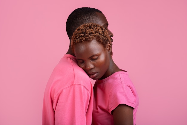 Medium shot couple posing with pink outfit