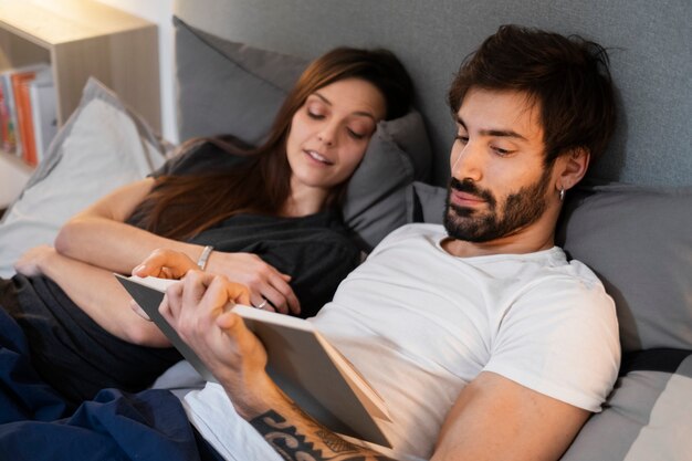 Medium shot couple reading book