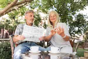 Free photo medium shot couple reading news