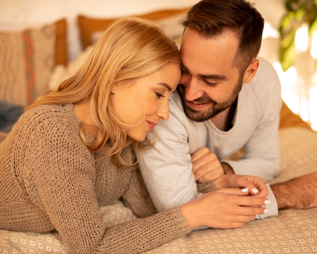 Medium shot couple relaxing indoors