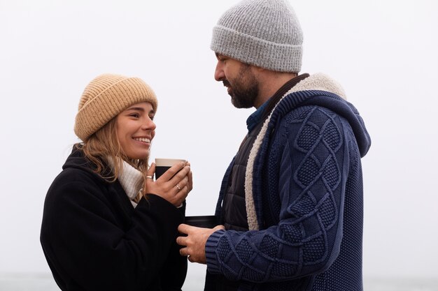 Medium shot couple spending time at seaside