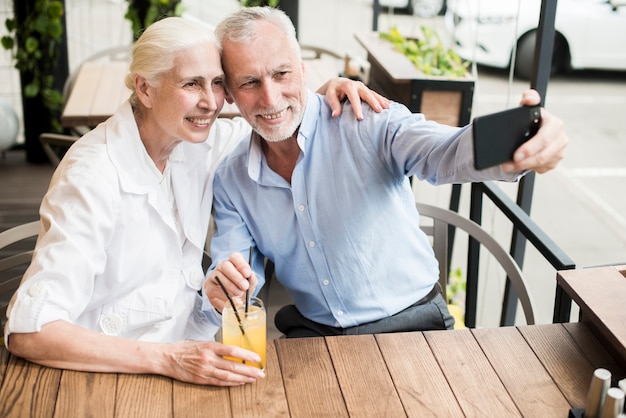 Medium shot couple taking a selfie