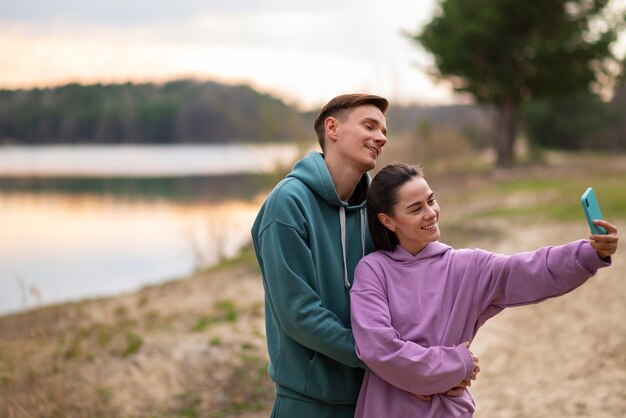 Medium shot couple taking selfie