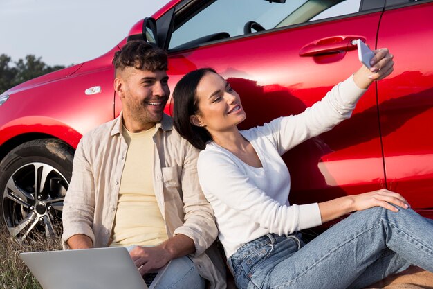 Medium shot couple taking selfies