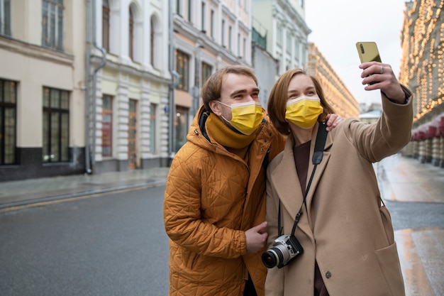 Medium shot couple traveling together in city