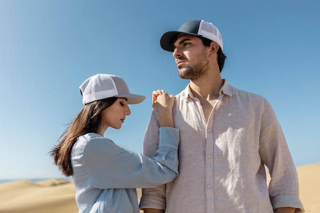 Medium shot couple wearing trucker hats