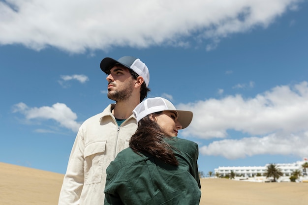 Medium shot couple wearing trucker hats