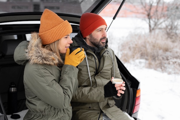 Medium shot couple wearing warm clothes