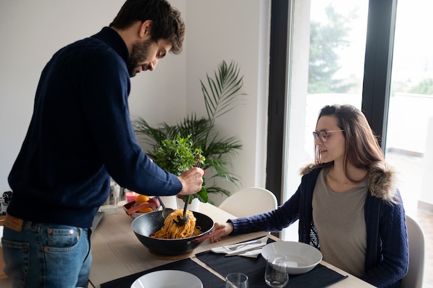 Medium shot couple with food at home