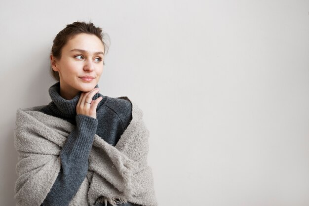 Medium shot cozy woman at home with copy space