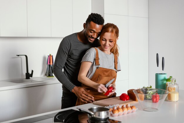 Medium shot cute couple cooking