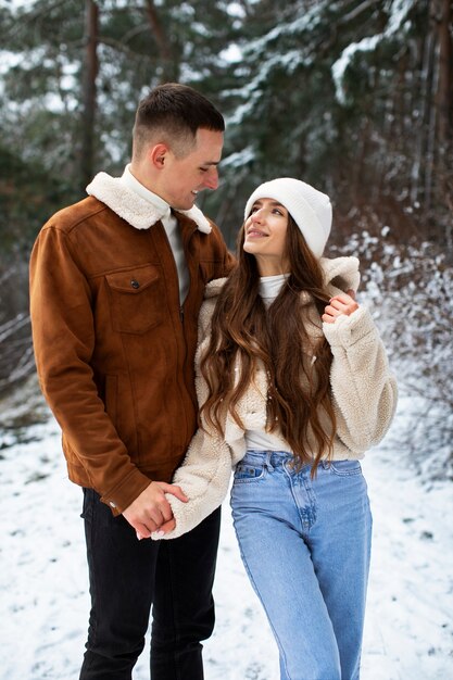 Medium shot cute couple holding hands