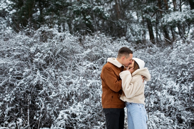 Medium shot cute couple kissing