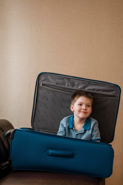 Medium shot cute kid laying in luggage