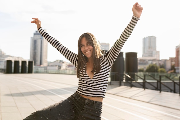 Medium shot cute smiley woman posing on sunlight