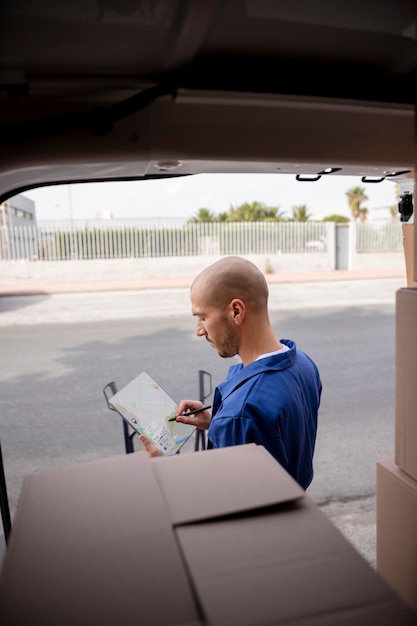 Medium shot delivery man with tablet