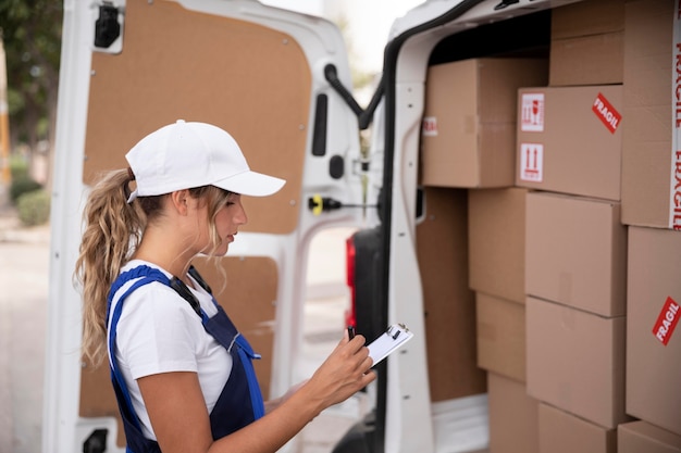 Medium shot delivery woman with van