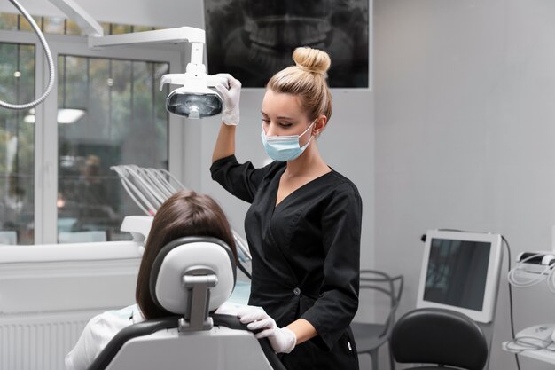 Medium shot dentist wearing face mask