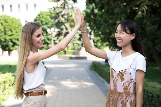 Free Photo medium shot of diverse friends high fiving