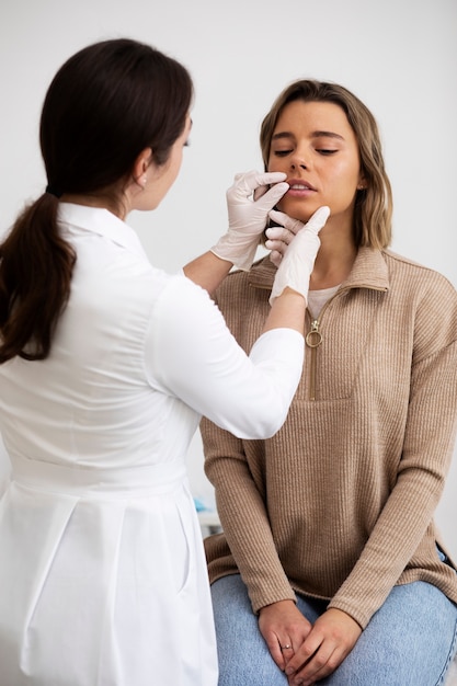 Medium shot doctor checking patient