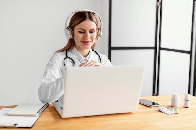 Medium shot doctor at desk