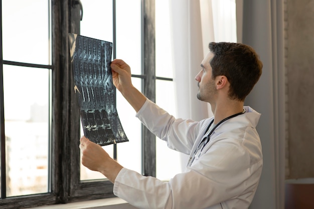 Medium shot doctor holding radiography