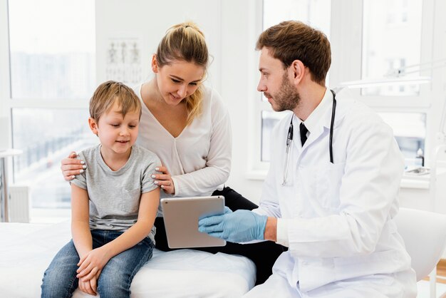 Medium shot doctor holding tablet