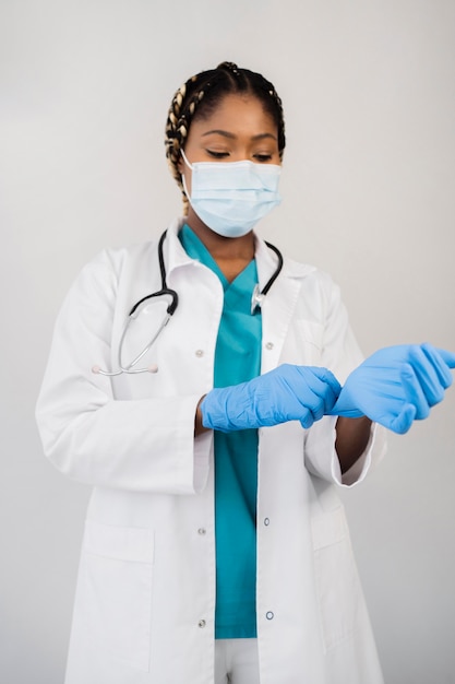 Medium shot doctor putting on gloves