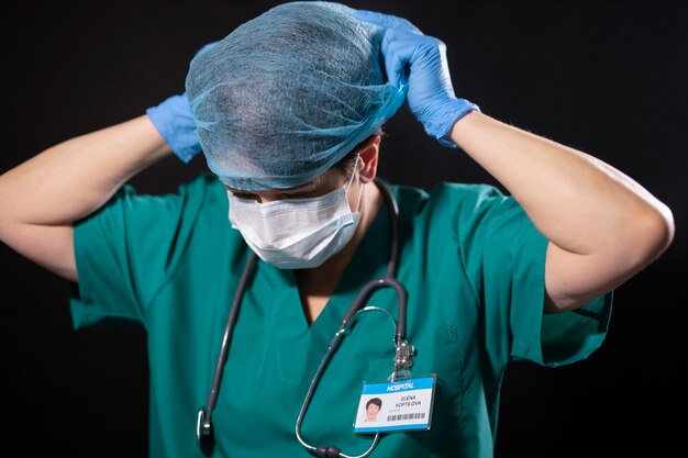 Medium shot doctor putting on hair net